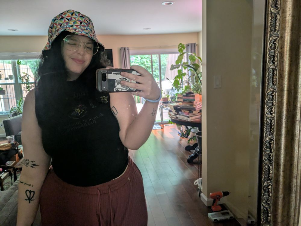 me in a pink pair of pants, extremely faded hogwarts tank and an epcot hat