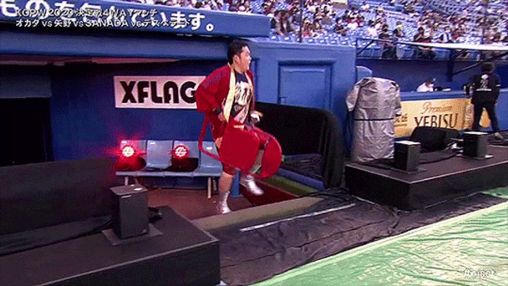 a man is jumping in front of a xflag sign