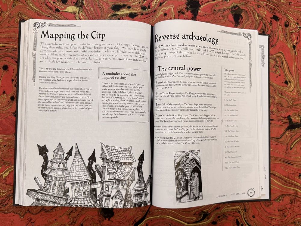 An interior example from His Majesty the Worm. Pages have intricate fantasy/Art Nouveau-style embellishments in the top corners, intricate pen and ink-style fantasy illustrations, and calligraphy font titles. The lefthand page is titled Mapping the City, includes a section called A Reminder Of The Implied Setting, and an ilustration of a variety of multi-story buildings with sharp shingled roofs. The righthand page is titled Reverse Archaeology and includes a subsection on The Central Power as well as a small illustration of an ornate archway with figures standing beneath it