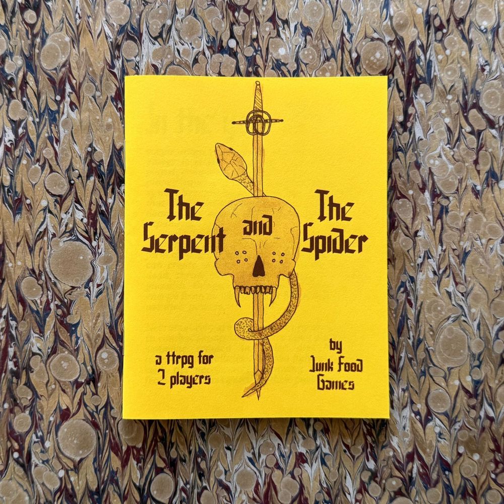 The cover of The Serpent and The Spider, a ttrpg for 2 players by Junk Food Games. Yellow paper with black ink, calligraphy font for the text, and, in the center, a hand-drawn vampire skull with a sword through it, accented by a snake