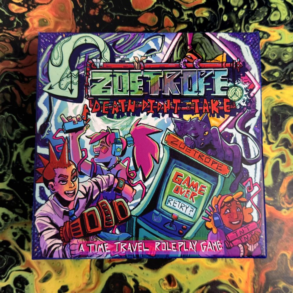 The box lid to Zoetrope: Death Didn't Take, subtitled: "A time travel roleplay game." The image is a color-saturated, 80s cartoon-style illustration of a group of three Time Agents boasting chaotic grins, their exaggerated weapons in their arms (explosives, big sci-fi gun). The screen on a vintage arcade game console called "Zoetrope" reads "game over, retry?"