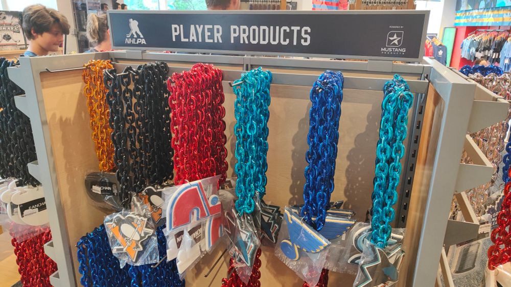Merchandise at the Hockey Hall of Fame.  A bunch of fake oversized chain link necklaces the sort of which you'd normally see in kink/fetish fashion.

The necklaces each have a different hockey team logo attached to them and are in an array of different colours.