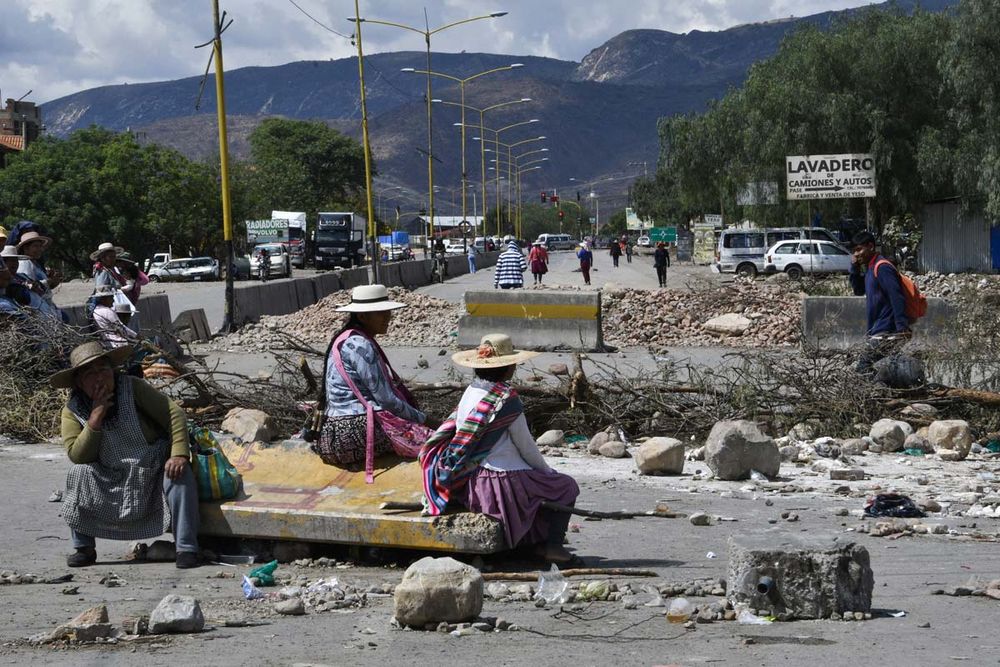 Supporters of former Bolivian President Evo Morales block a road linking Cochabamba with La Paz, near the village of Khora, 20 km from Cochabamba, Bolivia, on October 28, 2024. Former Bolivian president Evo Morales is being investigated for rape, human trafficking and human smuggling over his alleged sexual relationship with a 15-year-old member of his political youth guard in 2015. Supporters of Morales have protested by blocking major roads throughout the country for two weeks. Morales said gunmen tried to kill him Sunday in a hail of bullets, an attack he blamed on the current president.

AIZAR RALDES / AFP
