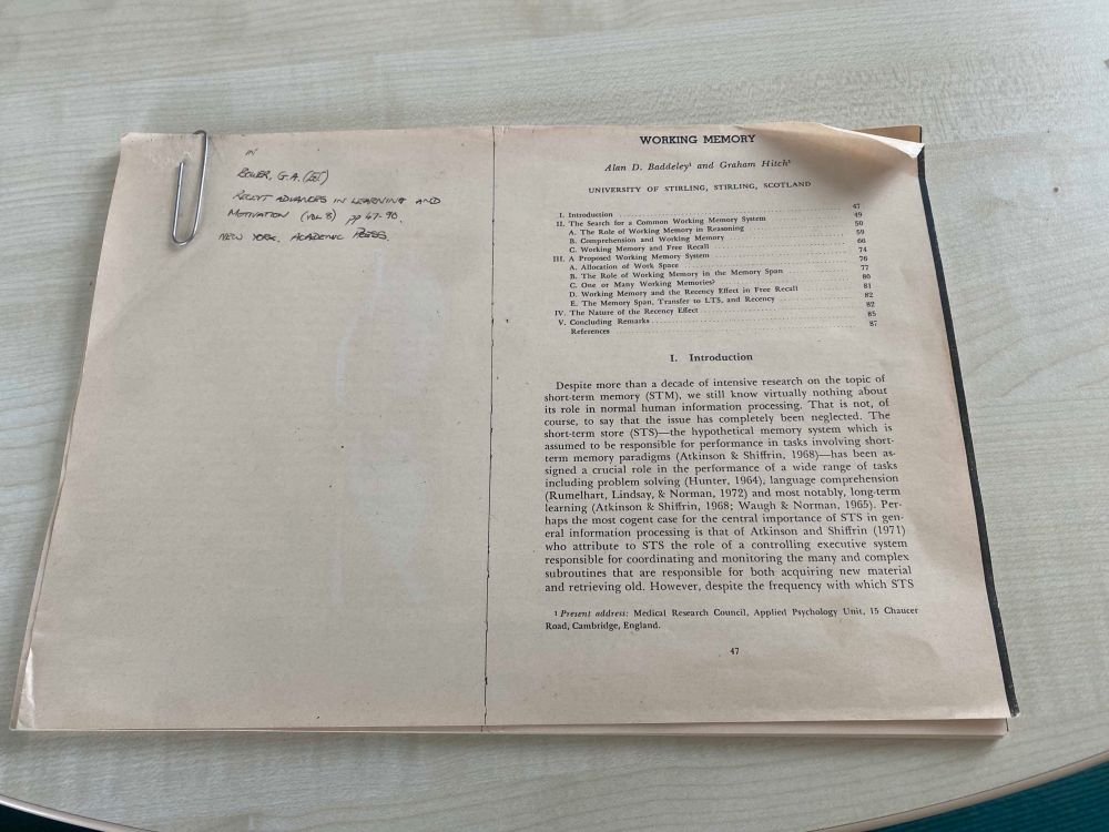 A photocopy of a research chapter on ageing and curled paper with a large paperclip holding the work together