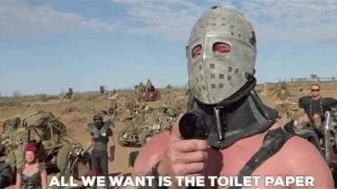 Still from The Road Warrior, where the Lord Humongous, a bodybuilding Warlord wearing a hockey mask, holds a microphone to his mouth and shouts, "All we want is the toilet paper." 5y ago today the UK was reeling from panic buying due to new covid restrictions.
