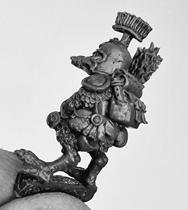 Rear 3/4 view of the "green" master sculpt for our Quint Eastduck adventurer model held between finger and thumb.