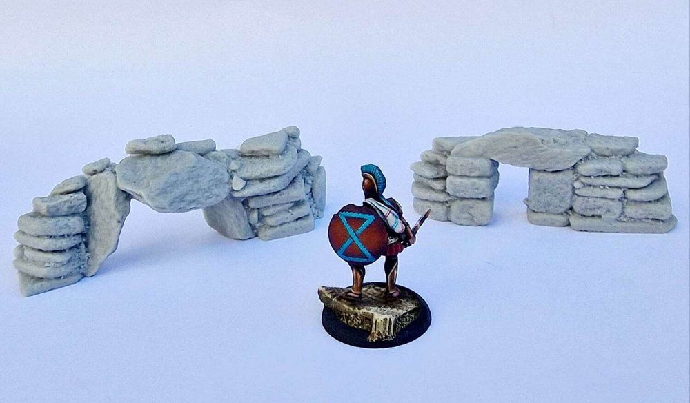Two resin barrow entrances shown with a 28mm adventurer for scale.