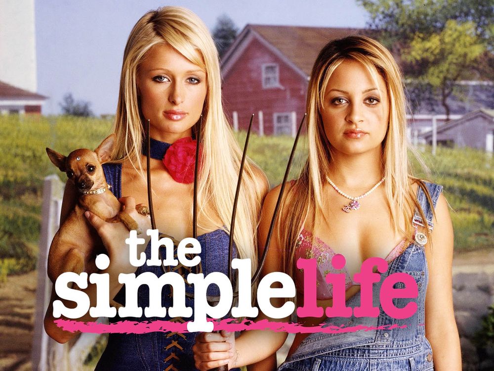 A promotional image for the tv series “The Simple Life” with Paris Hilton and Nicole Richie. The two women are wearing overalls and standing around on a farm.