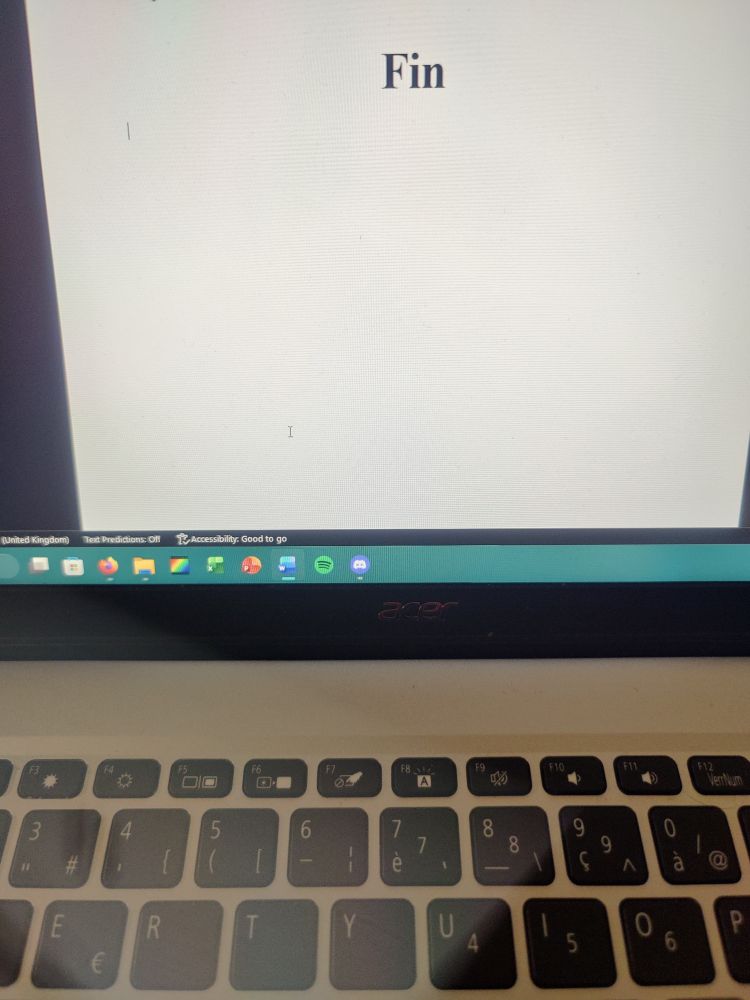 A picture of my computer, with Microsoft Word opened on the screen on the words "FIN"