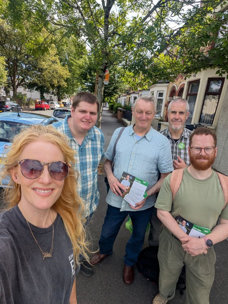 Anthony and volunteers leafletting in a tree lined street.