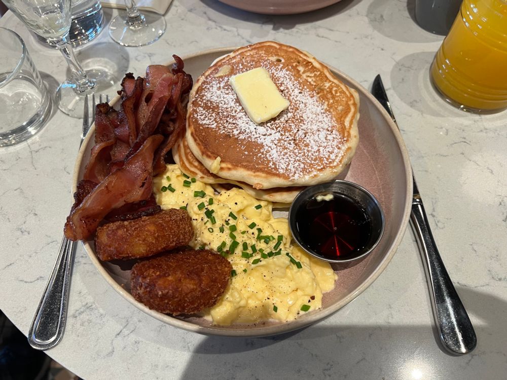 The Full Briekke, eggs, bacon, hashbrowns, and American pancakes and syrup. 