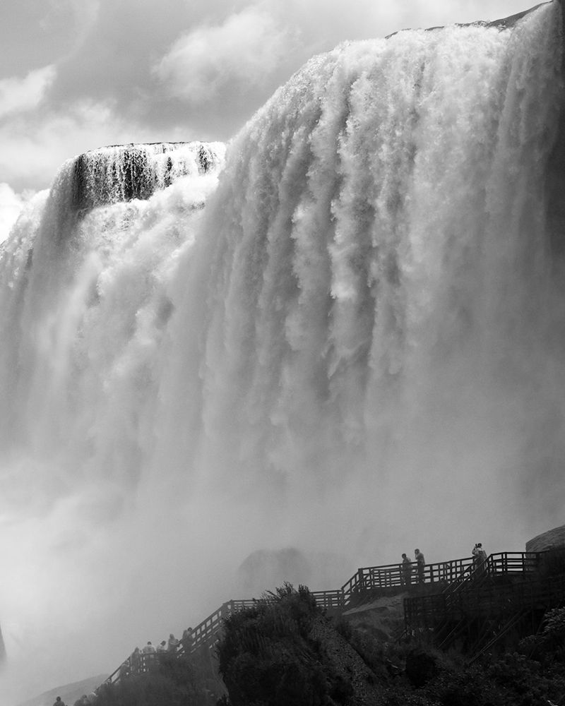 Black and white photo of tourists at the base of American and Bridal Veil Falls at Niagara. 