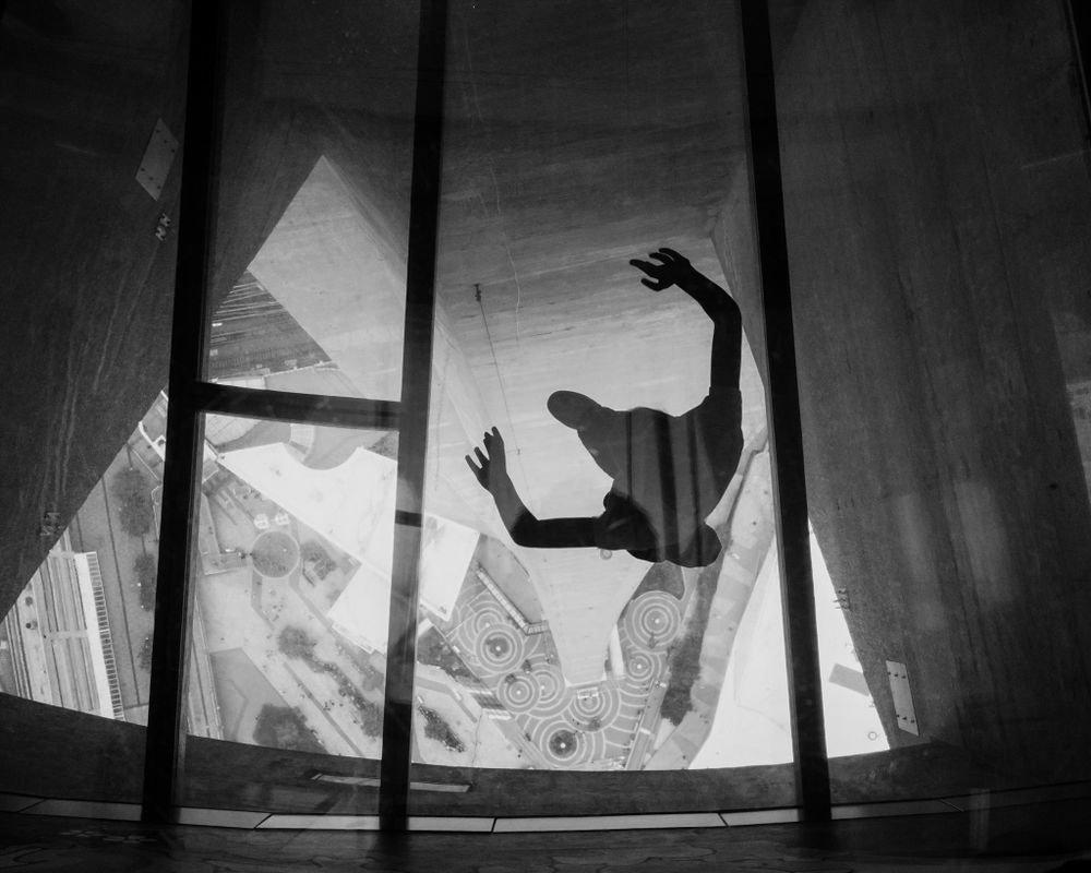 A figure seen through the glass floors of the CN Tower in Toronto. A7rV camera with 35/1.4 lens. 