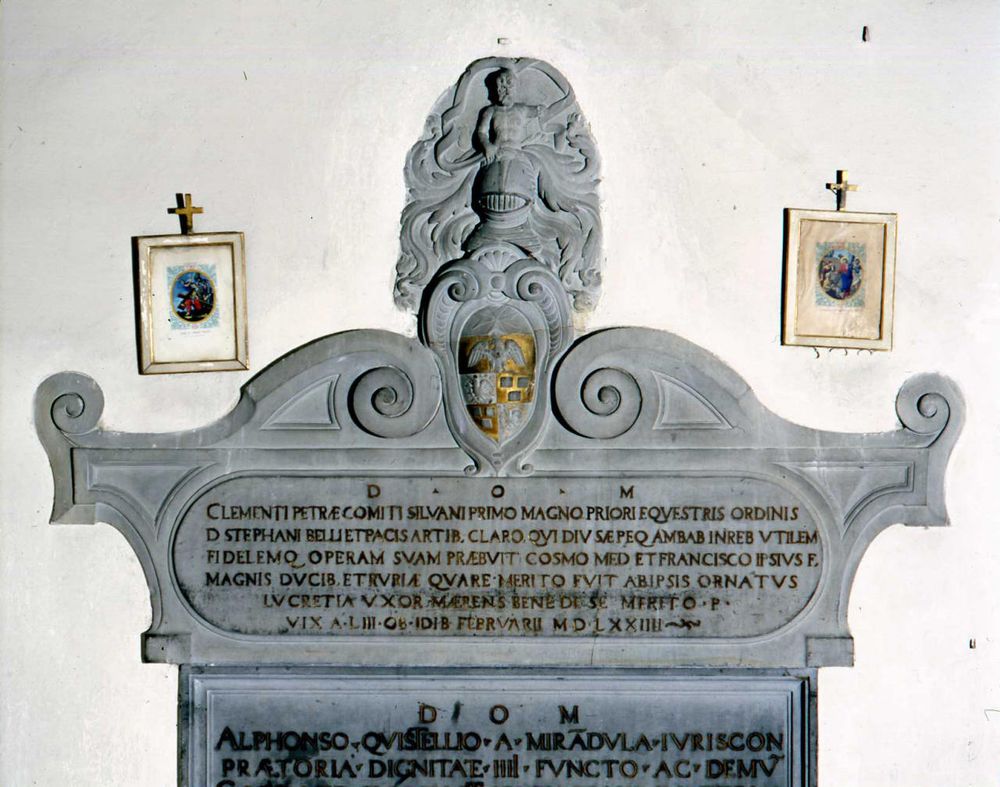 Wall tomb of Clemente Petra, Count of Silvano. Consists of a stone relief sculpture in the shape of a scrolled sarcophagus with a coat of arms at the center top over a lengthy inscription. See https://sepoltuario.iath.virginia.edu/memorials/31978 for more.