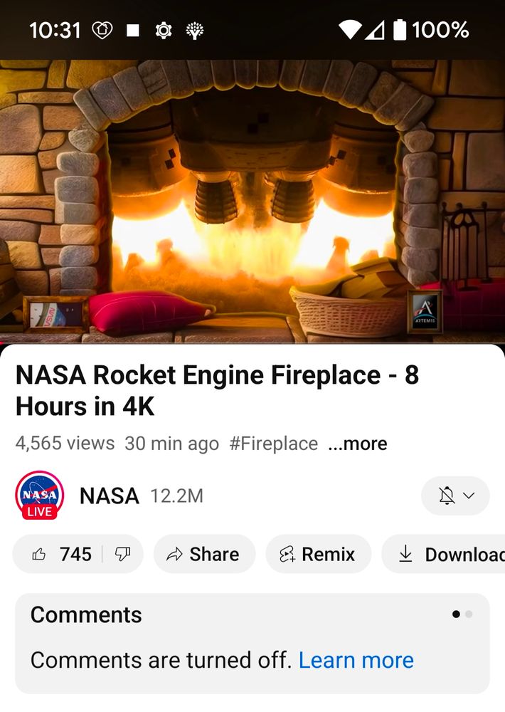 A screenshot of a YouTube video from NASA titled "NASA Rocket Engine Fireplace - 8 Hours in 4K". The thumbnail depicts an ordinary stone fireplace with rocket engines firing from inside the chimney.