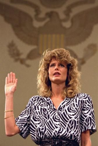 Fawn Hall raises right hand before Congressional testimony regarding her involvement in the Reagan Iran-Contra Scandal. 