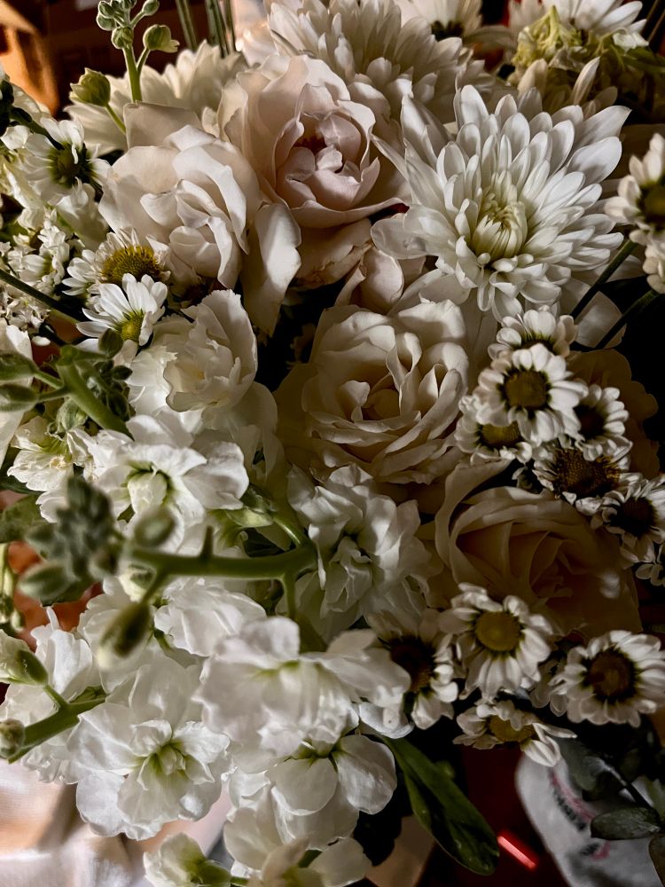 Bouquet of various white flowers, stock, roses, mums, daisies 