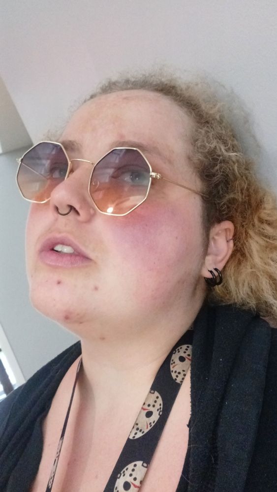 Pic of op wearing sunglasses with vague white background