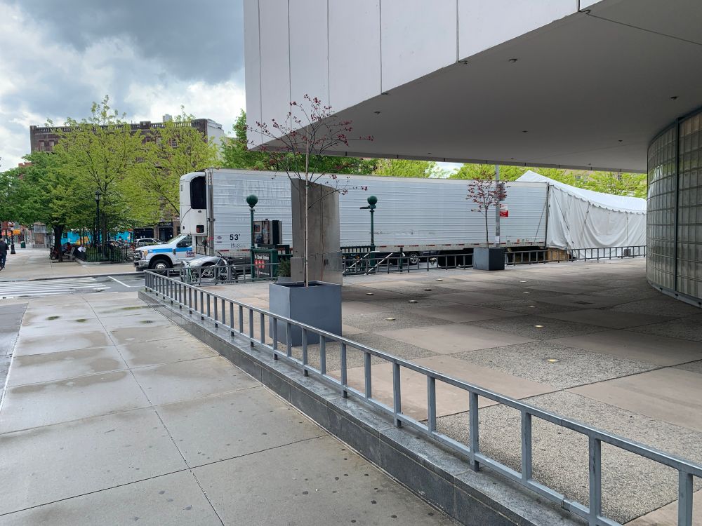  May 2020, a long white truck parked outside of an emergency room in NYC to act as a temporary morgue 