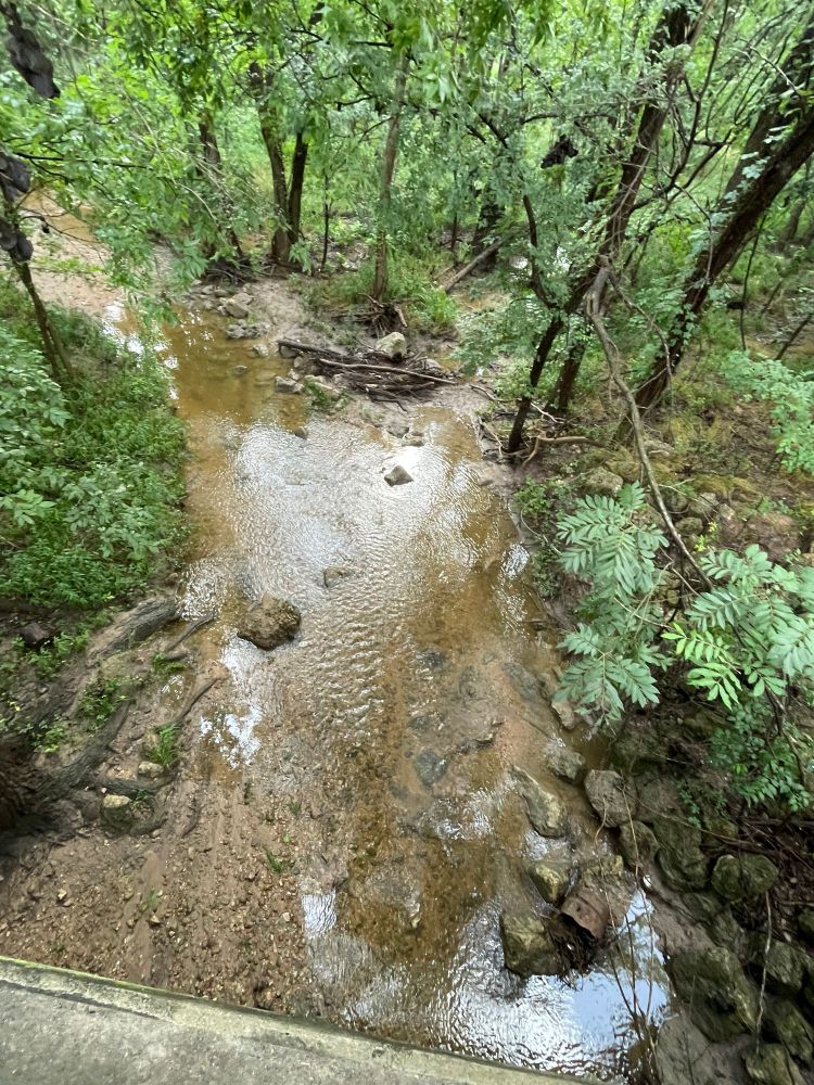 The same creek two weeks later, the day after heavy rains flooded central Texas.