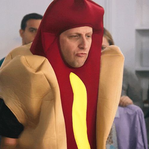 a man is dressed as a hot dog with a yellow stripe