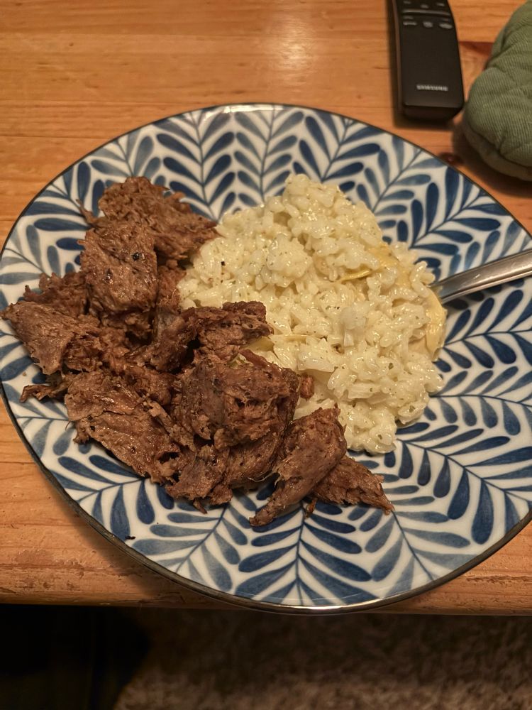 a plate of risotto and pulled mushrooms that look so much like chunks of steak