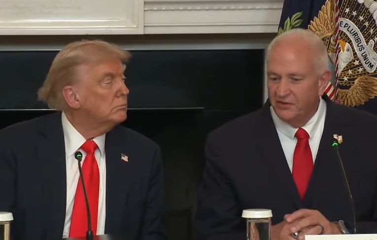 Trump sitting next to another man with a very similar tie that's better in every way