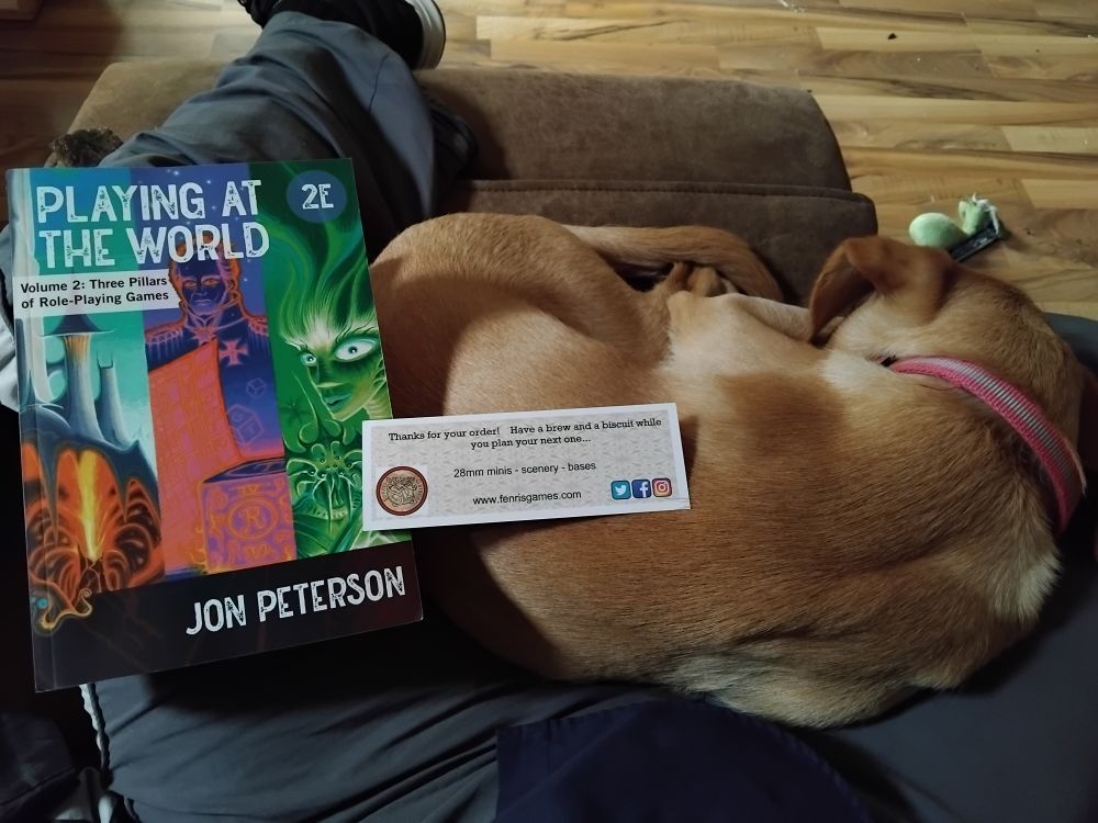 Puppy Ren resting on lap whilst I'm reading Playing at the World