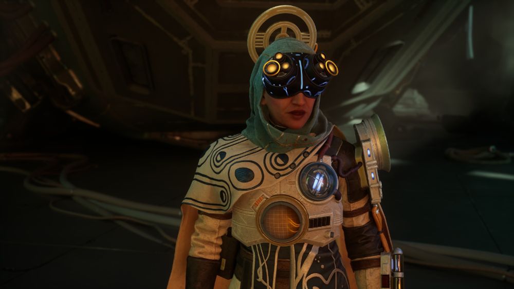 Marisol, from The Outer Worlds 2. She is in white with flowing clothes and cape, her clothing is patterned with blue circles. She is wearing a head scarf and a huge blue visor with yellow lights.