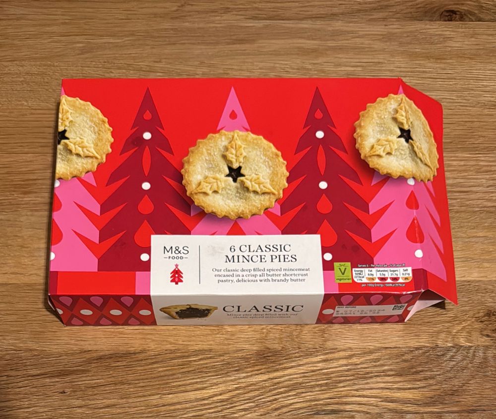 An opened box of mince pies: M&S Food, 6 classic mince pies. The box is red and festive.