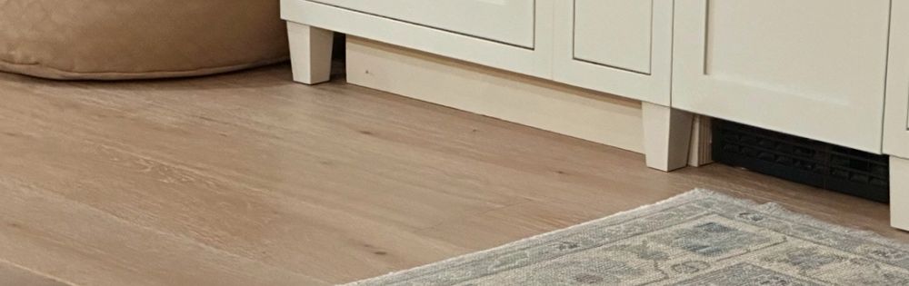 Close up of cabinet with feet, and a hidden toe kick or something being stored underneath the cabinet or? 