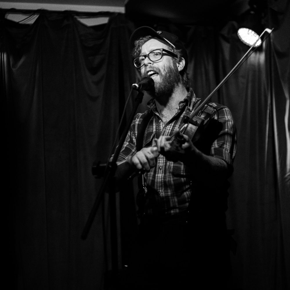 Matt Heckler playing fiddle and singing at the Skylark Lounge in Denver.