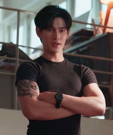 Pavel Naret Promphaopun with his arms crossed in a Very tight t-shirt