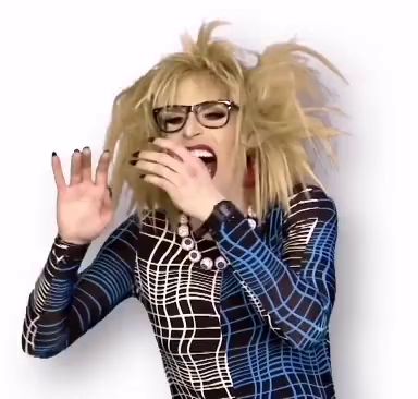 a woman wearing glasses and a plaid shirt is covering her mouth with her hands