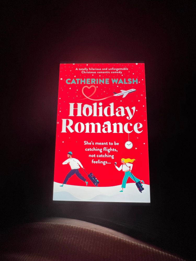 kaiti is reading holiday romance by catherine walsh on her tablet 