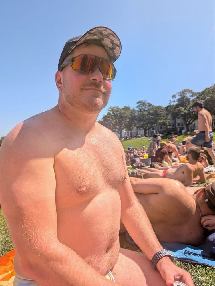 Mustached man shirtless with sunglasses
