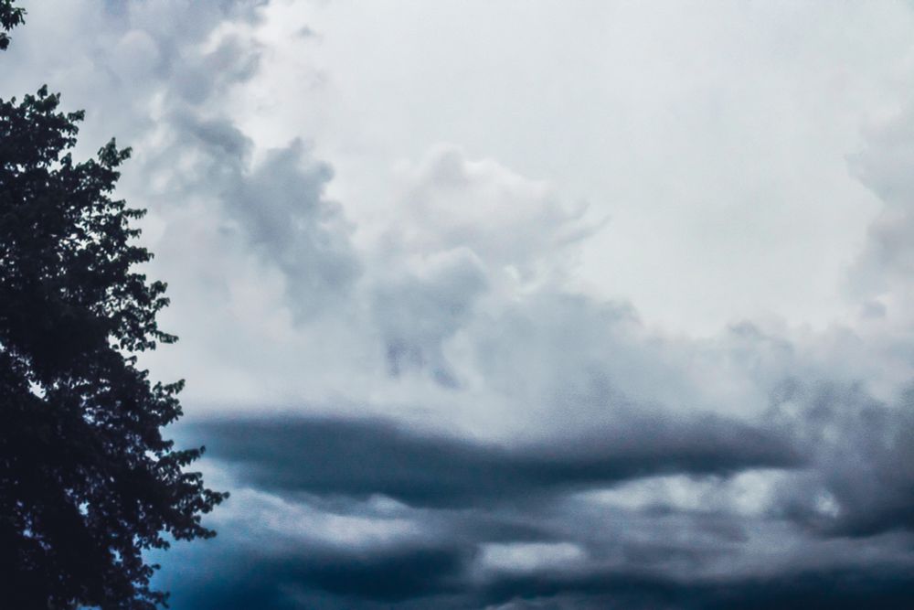 Approaching tornado warned storm with dark bluish grey base and white tops 