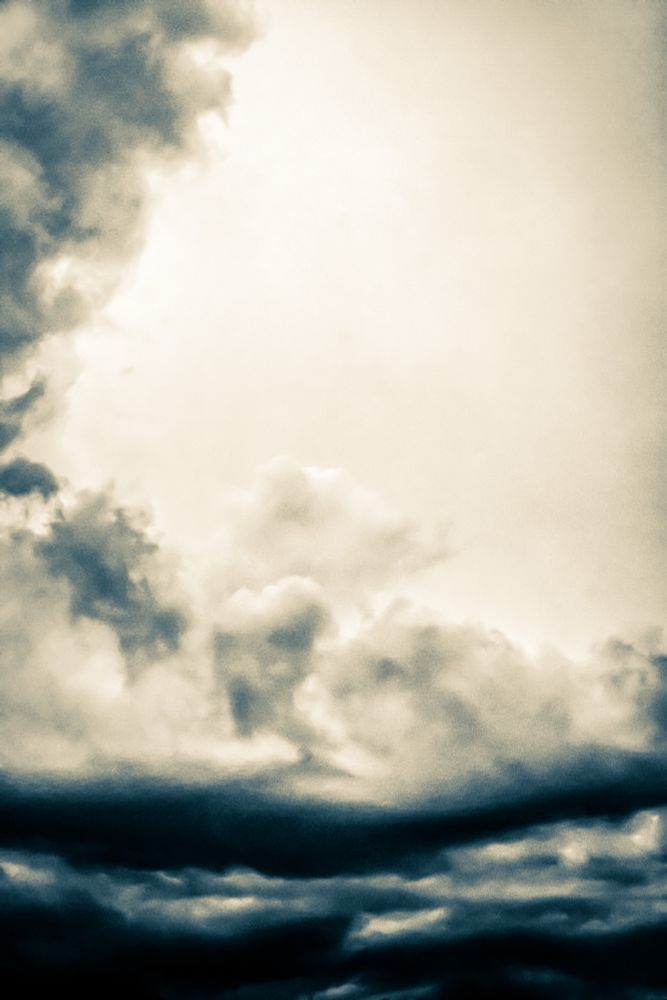 Agitated cloud tops visible on an approaching storm with a sepia3 filter added in Photoshop Express to highlight the dark base and accent the layers.  Playing with style on some of these storm photos, finding I like black and white brings mood and energy to grey skies 