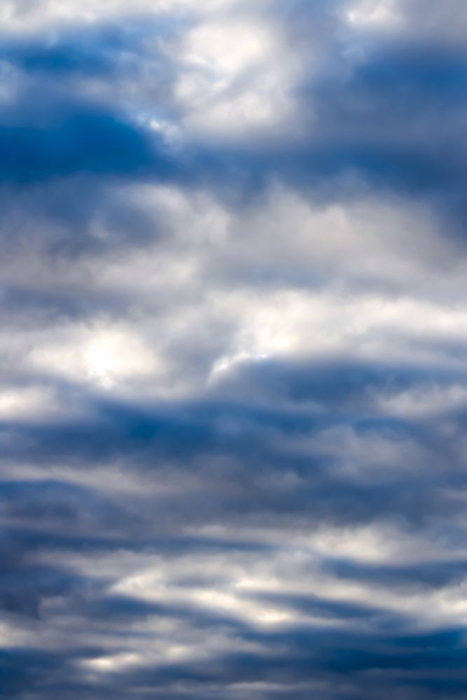 Cloudscape of sky shortly before sunset Sunday night, vibrant blue hues come through the grey overcast clouds.  New Jersey 