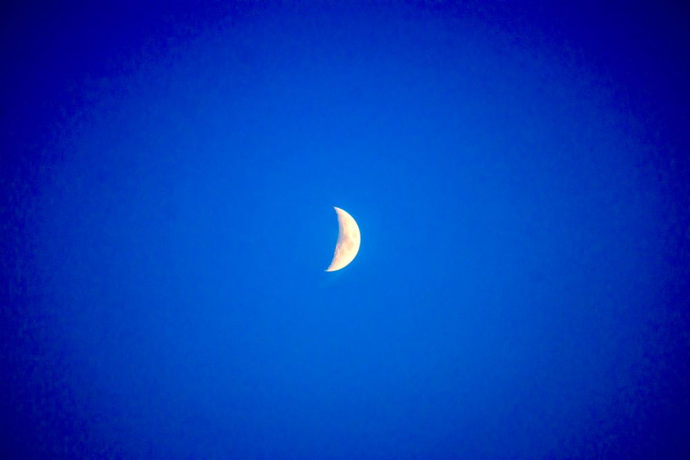The moon against a cerulean sky during the early evening hours tonight 
