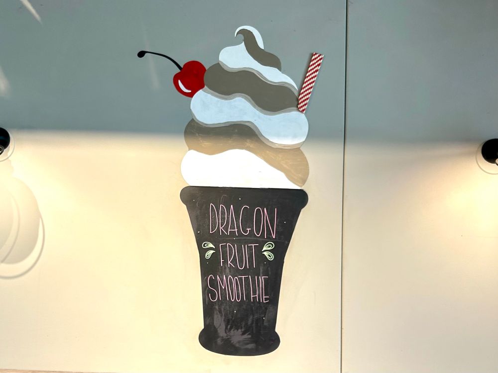 A painting on a wall of a sundae with the words “Dragon fruit smoothie” on it. I don’t know why I think this is funny. 