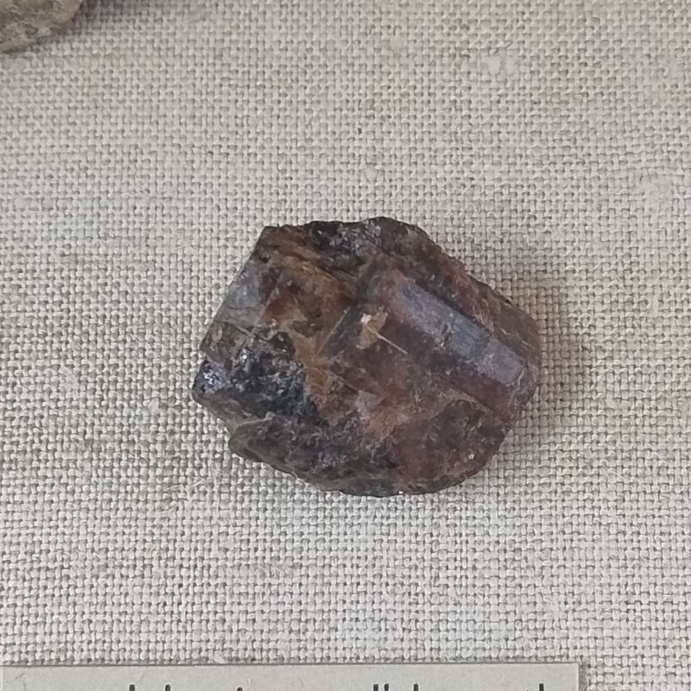 An opaque, brown bastnäsite crystal showing parallel growth. From Pike's Peak, Colorado, USA.

Specimen on display in the Natural History Museum, London.