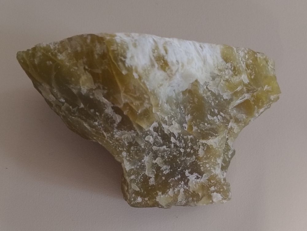 A greenish-yellow translucent mass of lizardite with some white patches on it. From Montville, New Jersey, USA.

Specimen on display in the Natural History Museum, London.