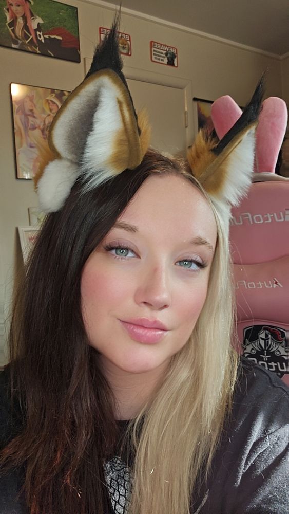 Side facing view try on of faux fur lynx style big cat ears