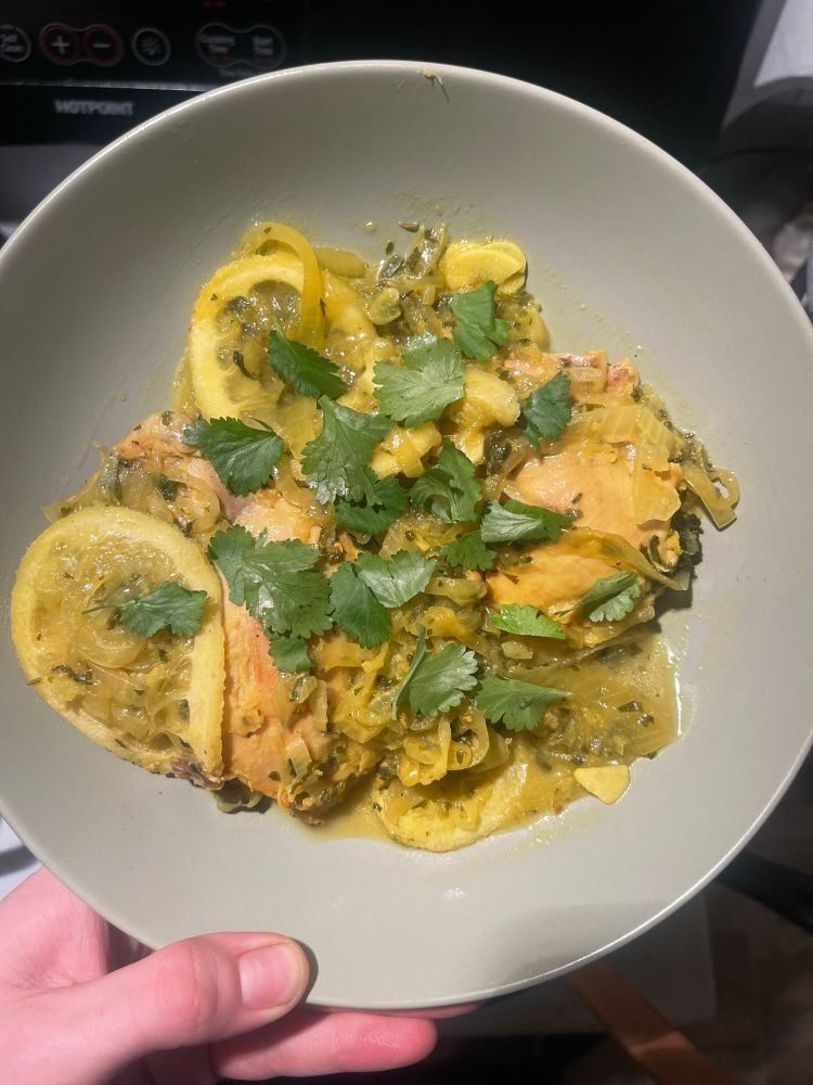 Chicken Tagine on a plate with lemons and cilantro