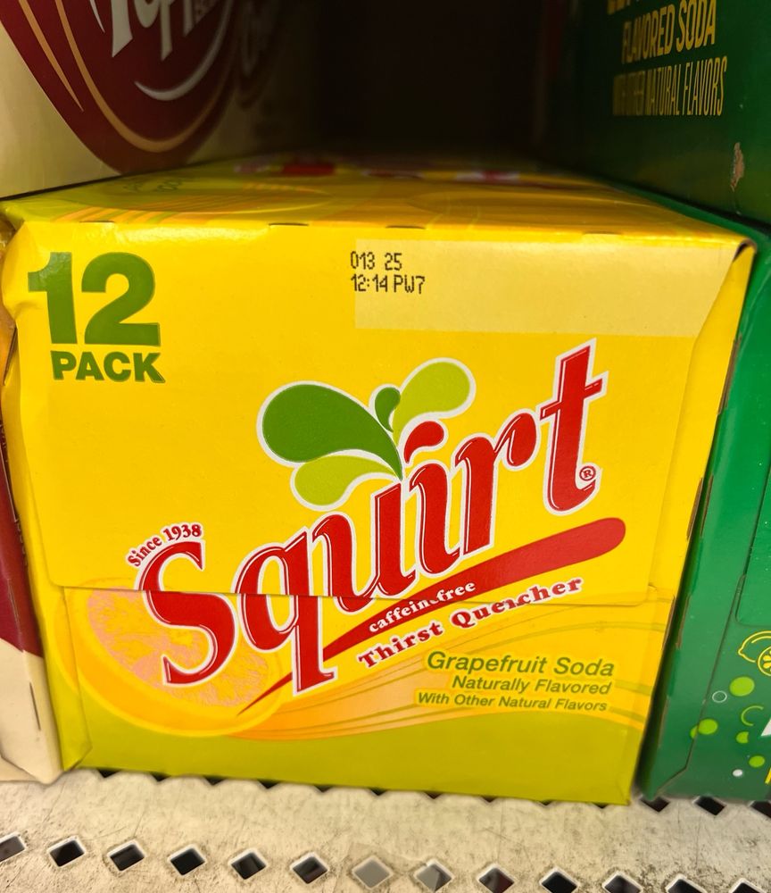 A box of “squirt” grapefruit flavored soda with the tagline “thirst quencher” under the name. 