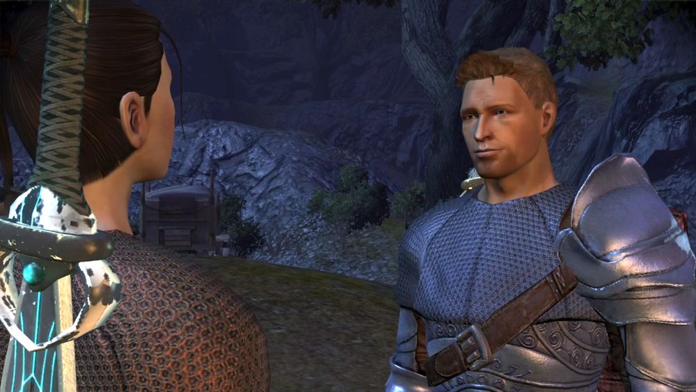 A screenshot from Dragon Age: Origins featuring Alistair Theirin and my Hero of Ferelden, Elaryn Cousland. They're standing opposite each other mid-conversation; Elaryn's back is to the camera. He's smiling with a hint of a smirk.