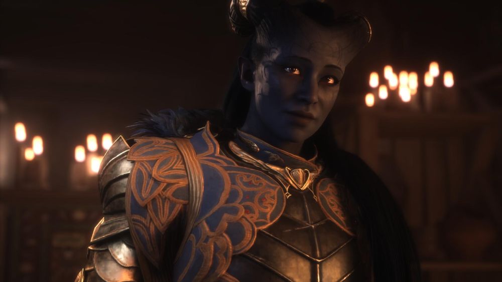 A screenshot from the game Dragon Age: The Veilguard featuring a portrait of my player character/Rook, Ruya. She's a Qunari with dark blue skin, black hair, and a combination of tattoos and decorative scars on her forehead and cheeks. Her horns are decorated with gold bands and she's wearing grey armor decorated with blue and gold. She has a friendly face and appears to be in her late thirties. She's indoors and the background features burning candles along the tops of wooden walls. 