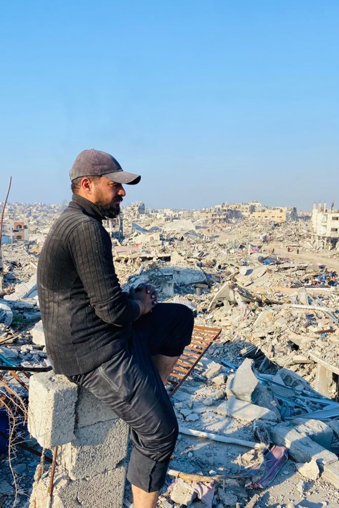 photo of omar looking at the destruction of gaza