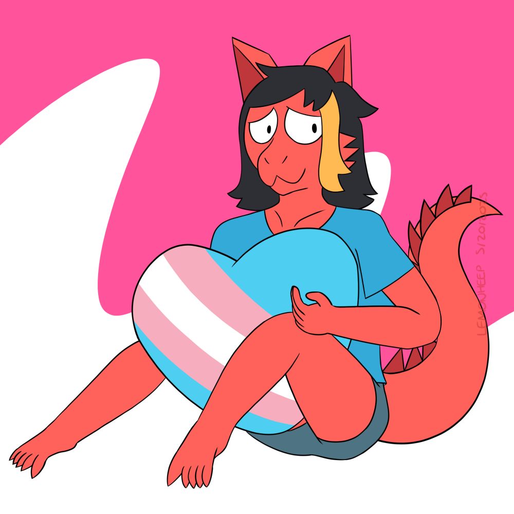 This is a digital artwork of Amber, a red dragon with a blue shirt and shorts by the artist FreonCat. She is holding a large heart that has stripes representing the trans pride flag (baby blue, pink, and white).